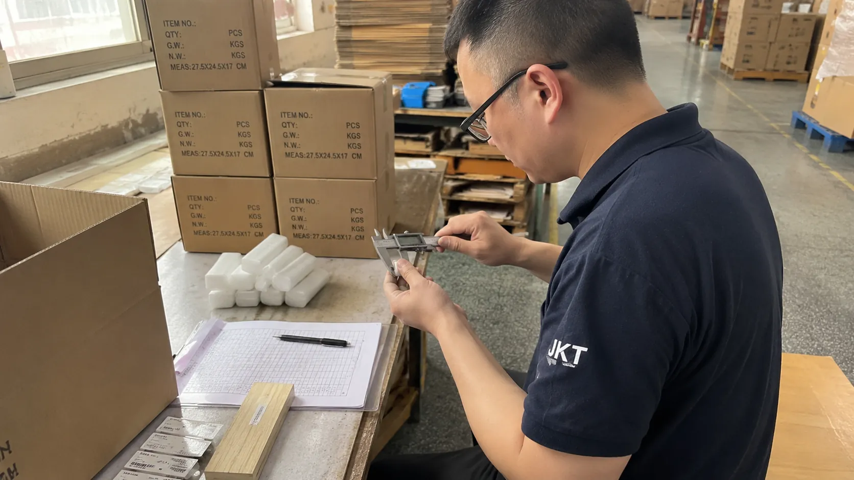 JKT team member measuring product components during a quality inspection