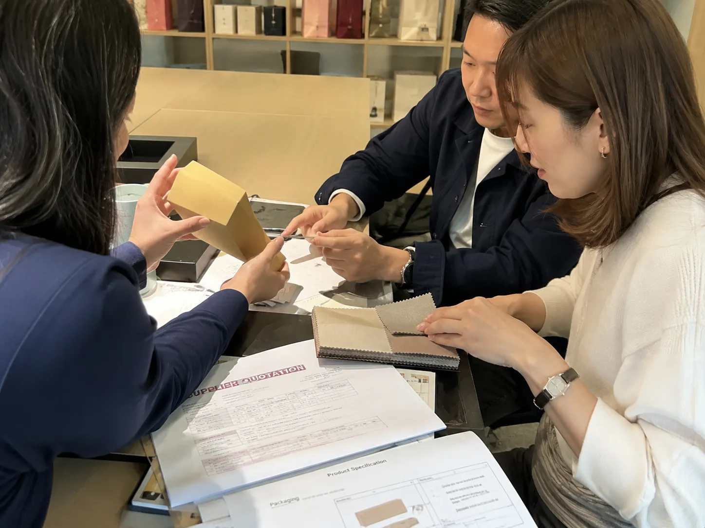 JKT team reviewing supplier quotations, materials, and product samples